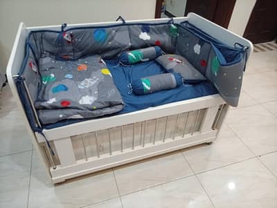 Baby cot with mattress and full bedding