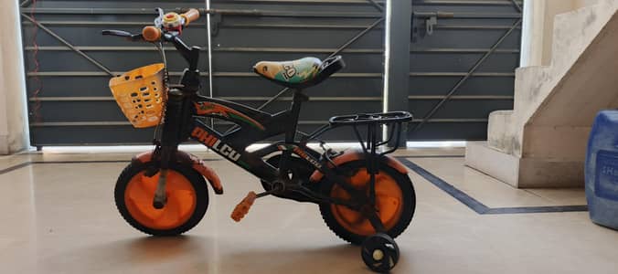 Used bicycle in orange colour with basket