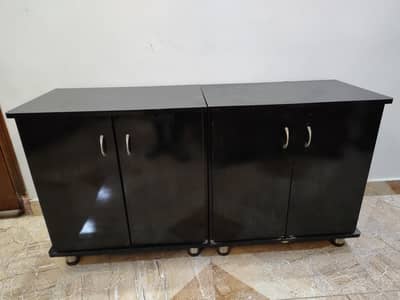 2 black cabinets and 2 vases with flowers