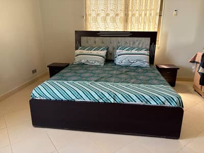 bed set with side tables and mattress.