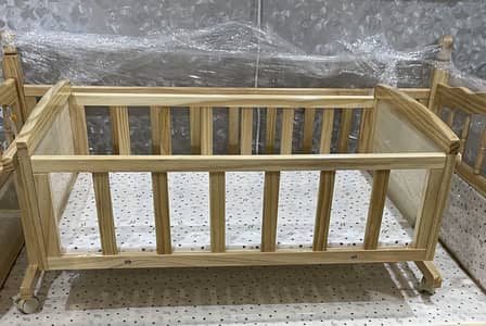 Baby cot in light wood colour