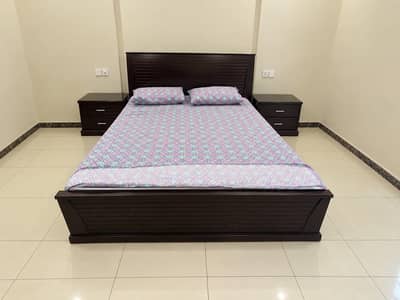 Dark brown king size bed set, with dressing table and side tables.