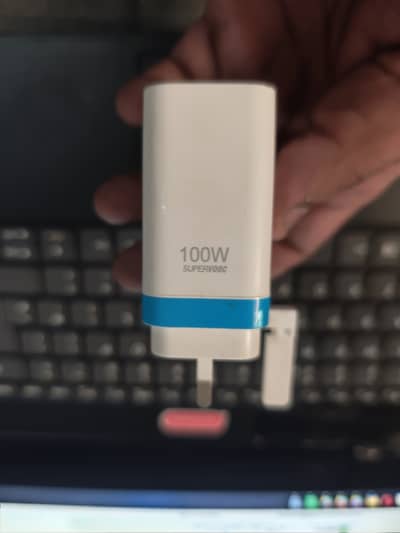 OnePlus 100W SUPERVOOC power adapter and original 10A charging cable.