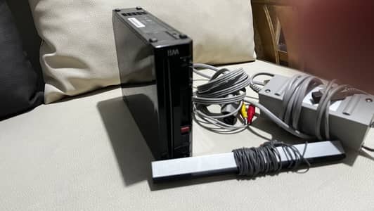 Nintendo wii console and 2 orignal cables and one sensor bar