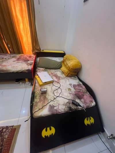 A kid bed along with mattress and built-in lights