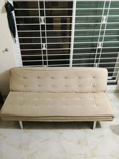 premium biege velvet sofa cum bed with steel stand