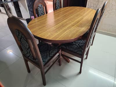 good quality wooden dining table with 5 matching chairs