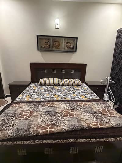 Wooden bed with side tables and dressing table and stool