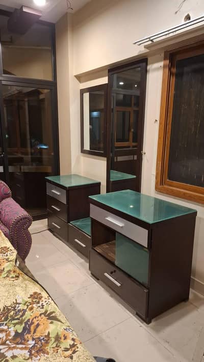 Double bed with mirrored side table and cupboards