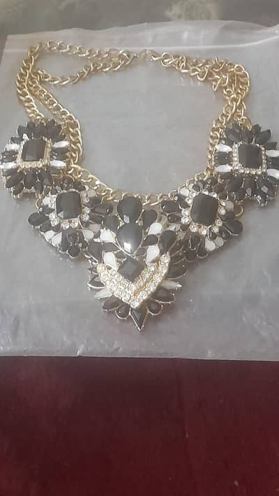 this item is an ornate black,white,and gold crystal bib statement neck