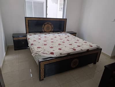 bed with mattress and side tables and dressing table