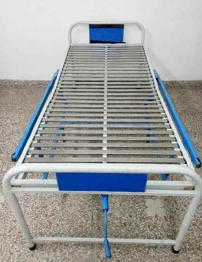 Medicated hospital bed with adjustable backrest and side railings.