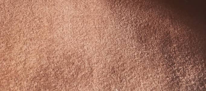 : Brown Textured Carpet Description: A close-up view of a
