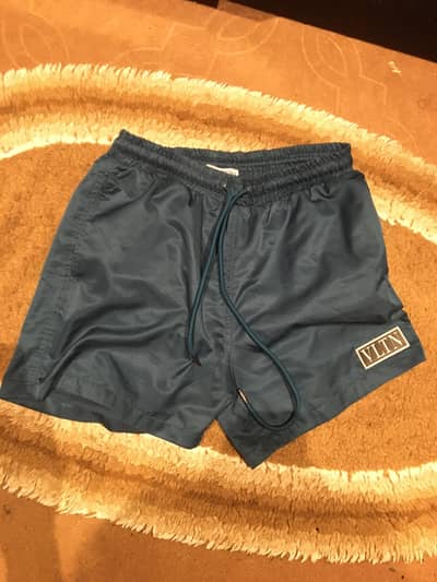 Valentino-branded swim shorts in teal blue, size S. Brought from Cypr