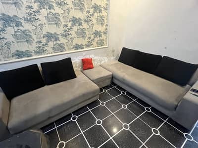 Grey colored 5 seater L shaped,2 stools and 2 single seater sofas.