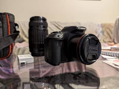 Canon EOS 600d with 56 mm f/1.8 lens and 75 - 300 mm lens
