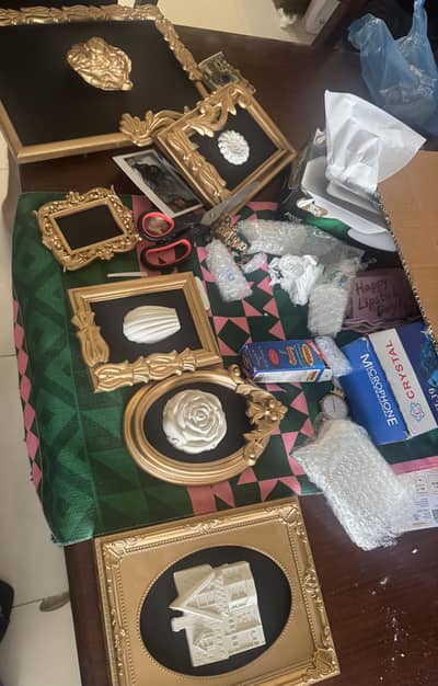 Set of 7 gold frames with sculptures