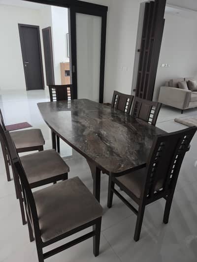 Unused wooden  Dinning table with 8 chairs