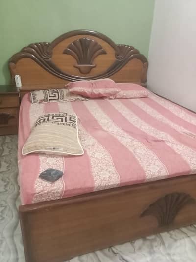 wooden bed with mattress
