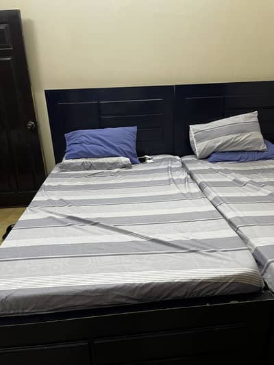 2beds with a cupboard and a middle table