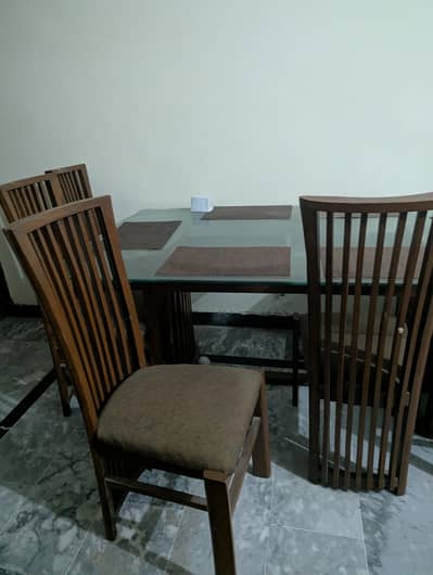 Glass-top dining table with six chairs