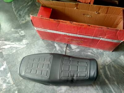 Original Seat of CD70 Dream motorcycle with new cover on it