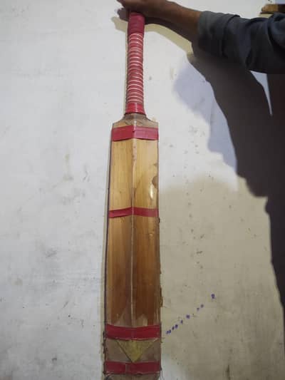 A pair of leather ball bat