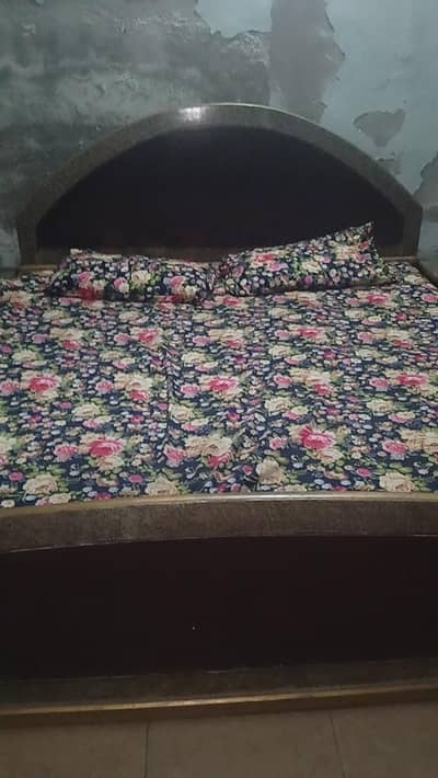 wooden king bed with 2 side tables and dressing table
