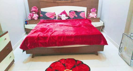 modern bed with 2 side table and a dressing table with showcase