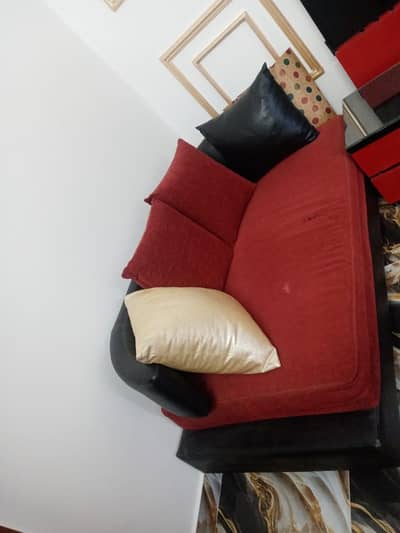Two seater neat and clean sofa in red and black colour