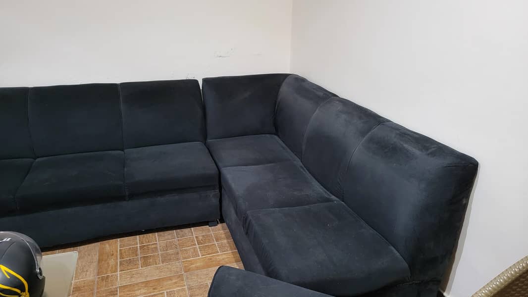 L shape Black colour sofa. 1