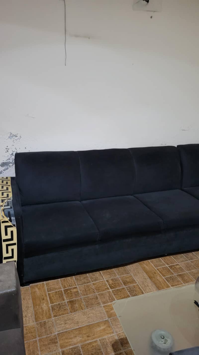 L shape Black colour sofa. 2