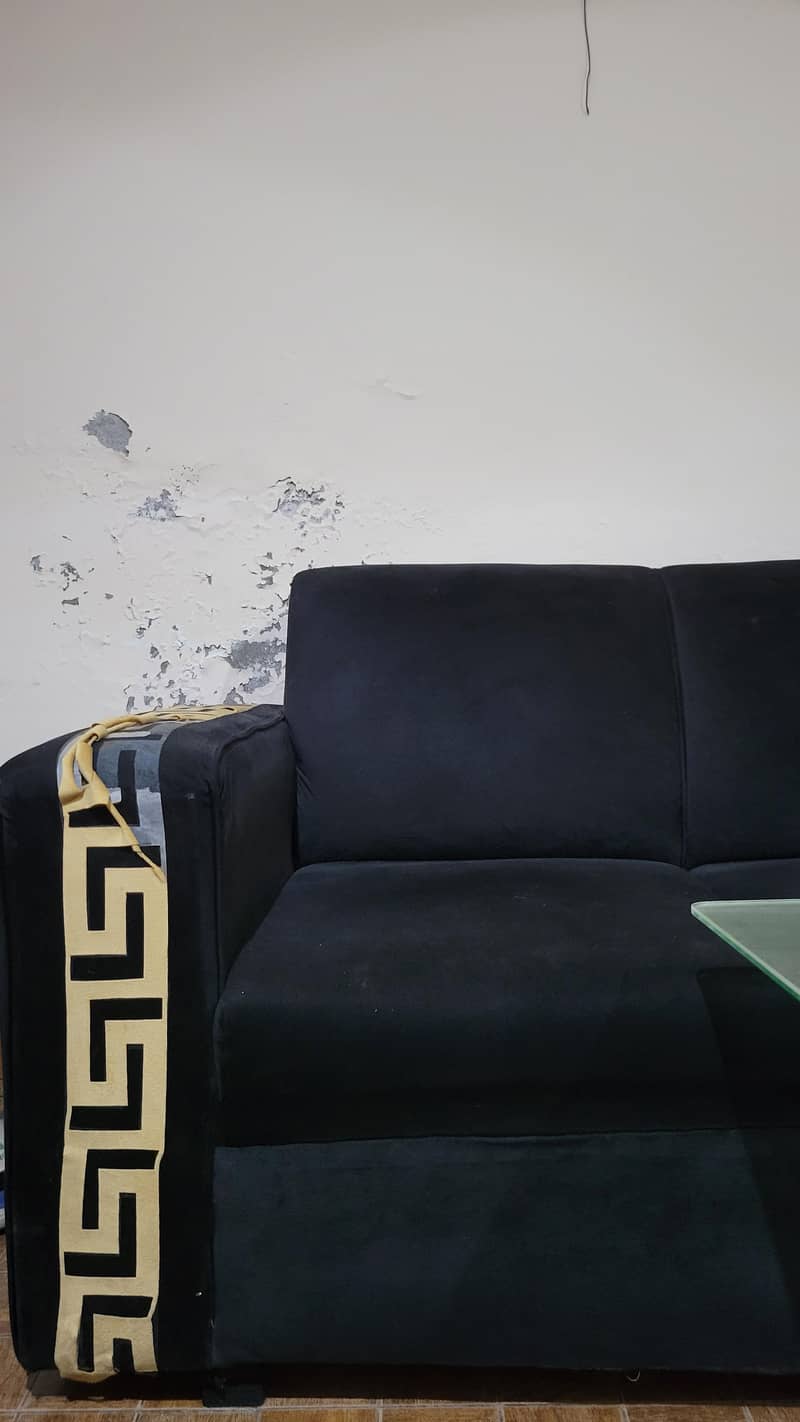 L shape Black colour sofa. 3