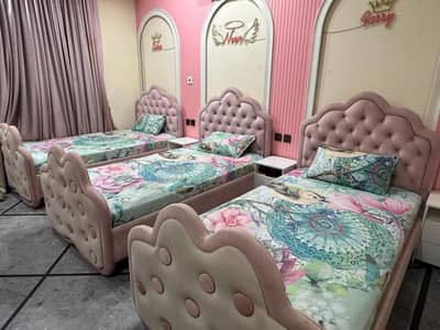 3 single beds along with three side tables and three chairs