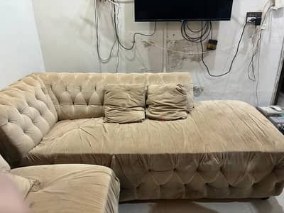 Used L shaped sofa set along with a matching center table and 4 stools