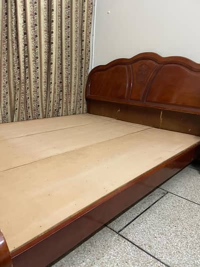 Wooden bed in good condition for sale.