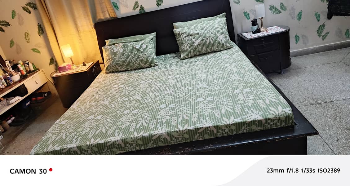 king size bed with one side table 0