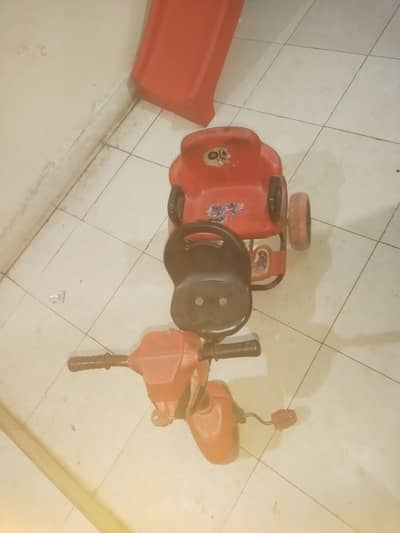 Red tricycle for kids with back support.