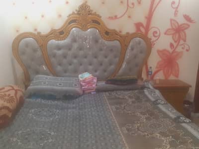 golden color King size bed with side table and dressing table
