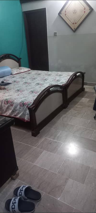 2 single wooden beds