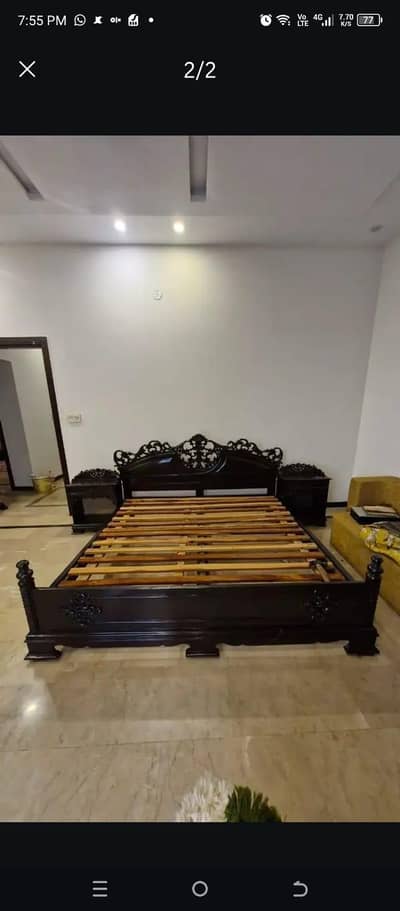 wooden carved king size bed with side tables and mattress